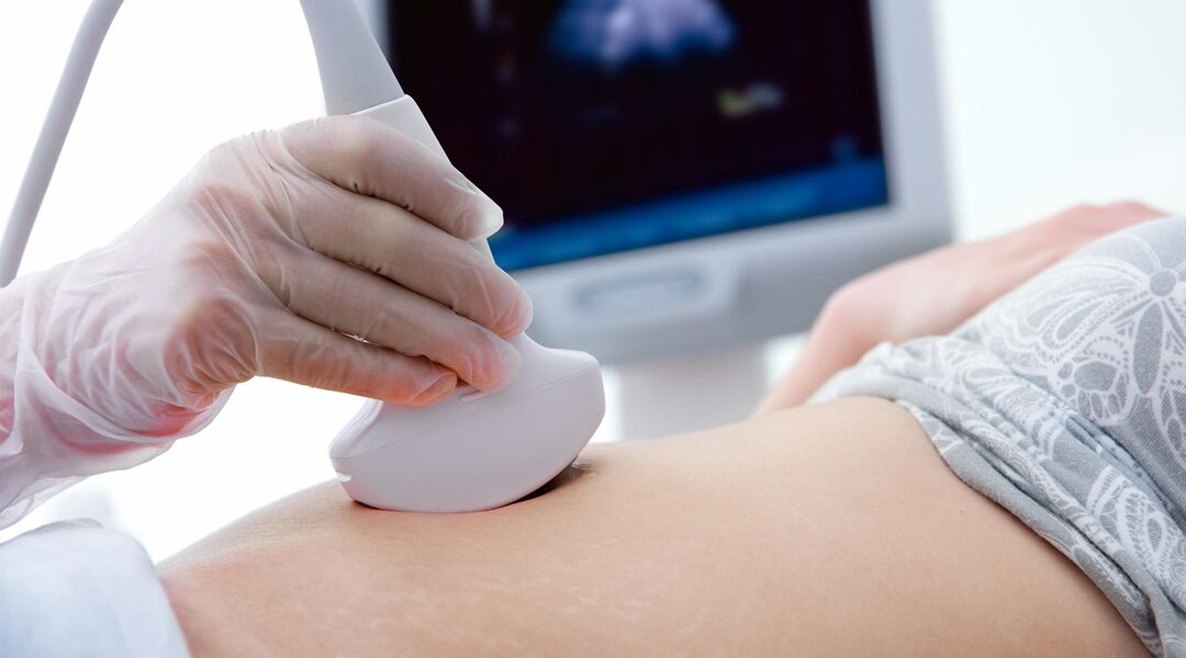 Doctor giving a pregnant woman an ultrasound exam