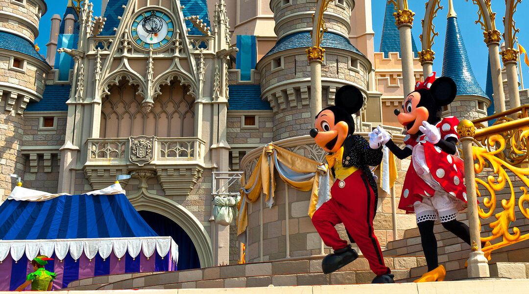 mickey mouse and minnie mouse performing by disney castle