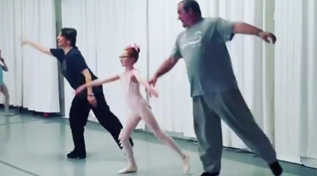 Dad mimicking daughter's ballet move