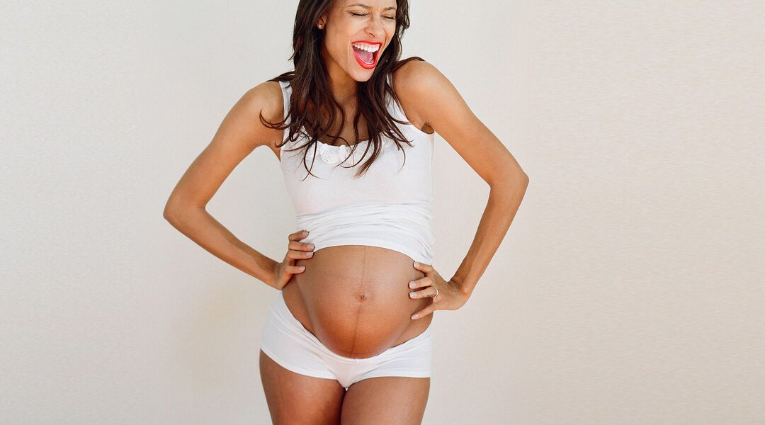 expressive pregnant woman laughing