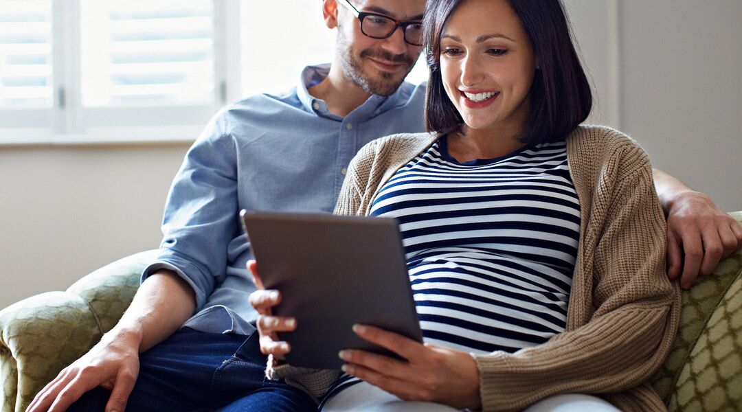 partner helping pregnant partner baby registry