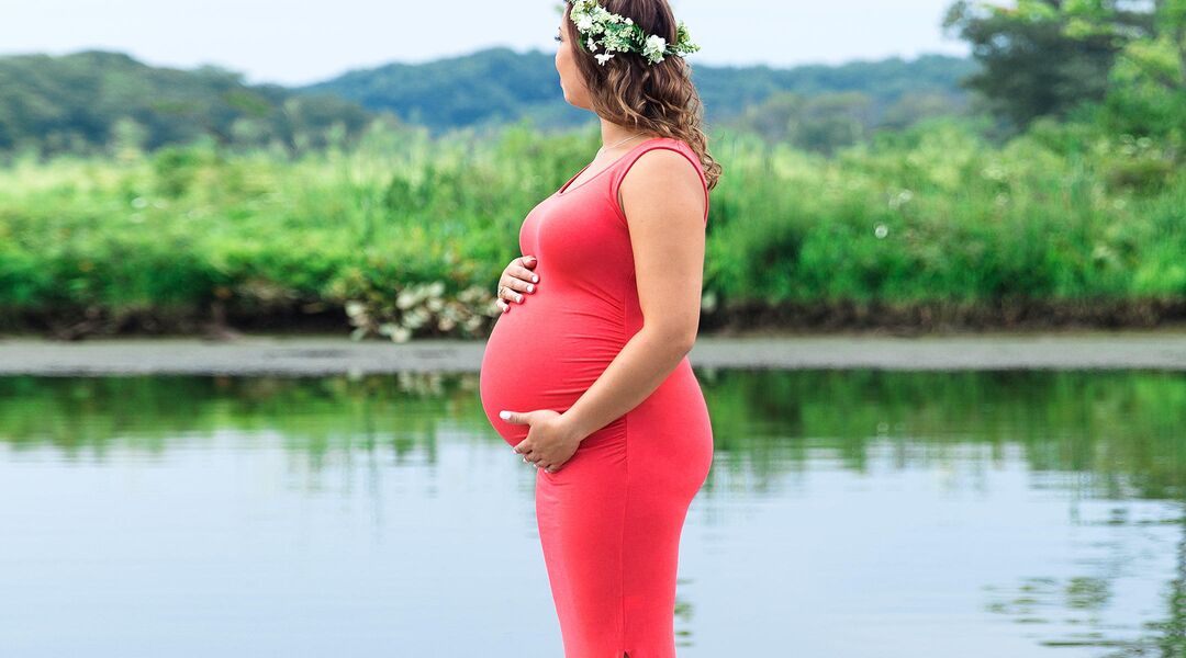 pregnant woman in nature with floral crown