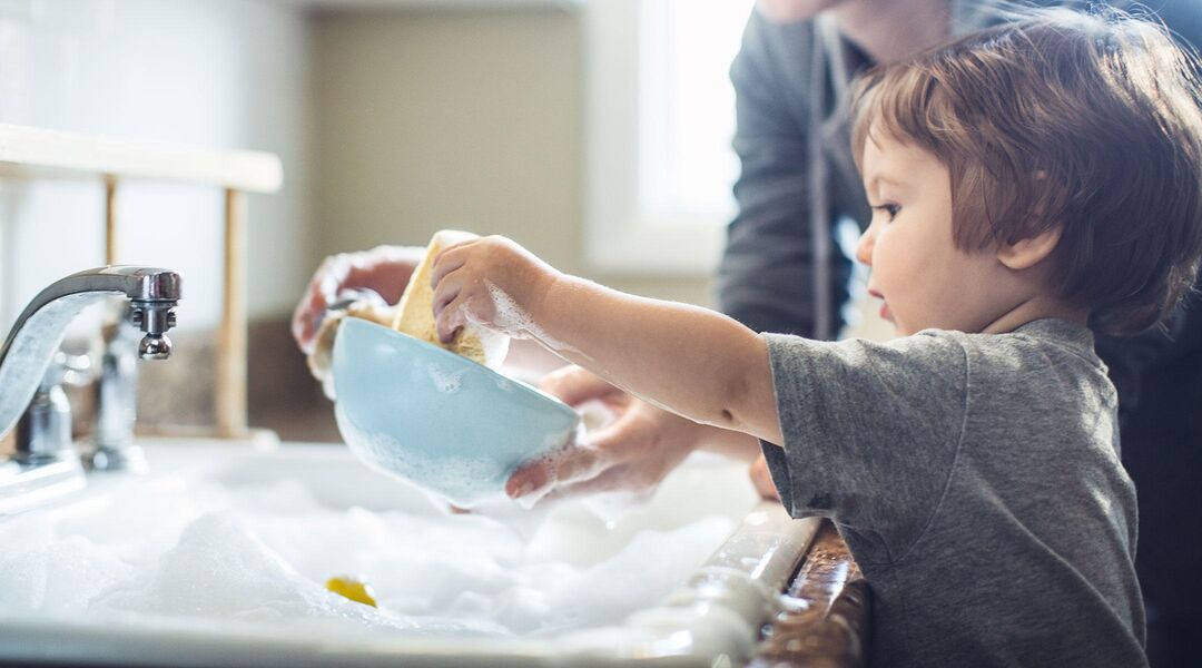 toddler helping mom clean dishes 