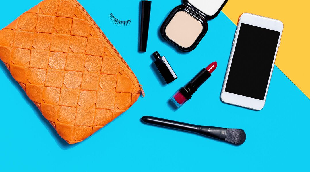 make-up bag flat lay beauty products