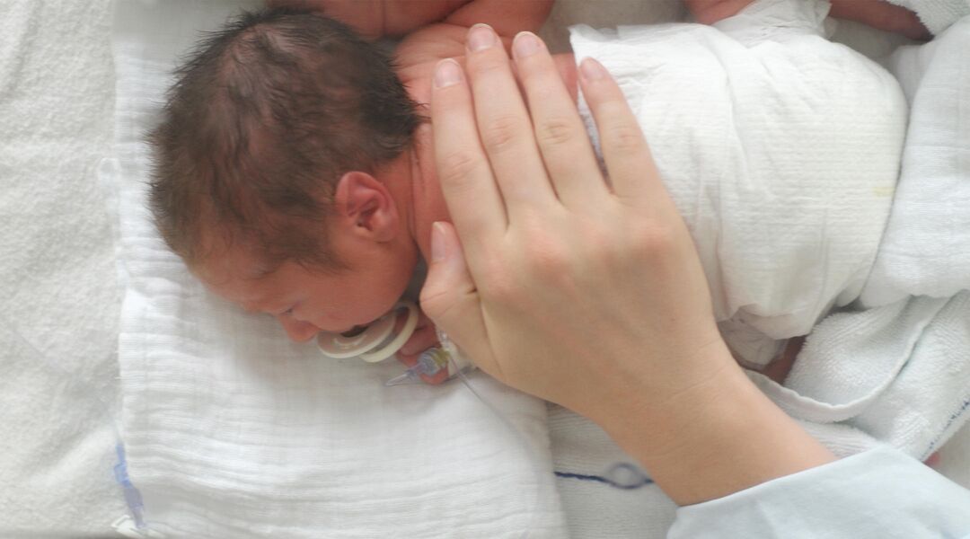 Parenting soothing sick newborn in hospital 