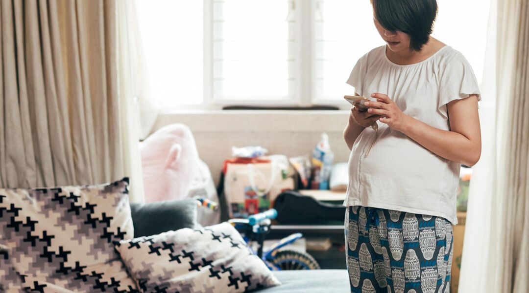 pregnant woman at home on phone