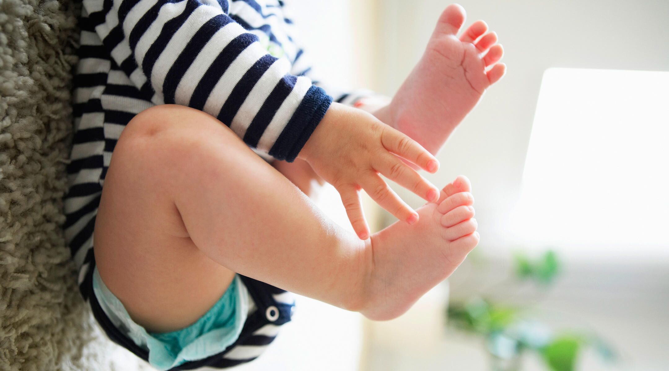 baby sleeps with knees bent