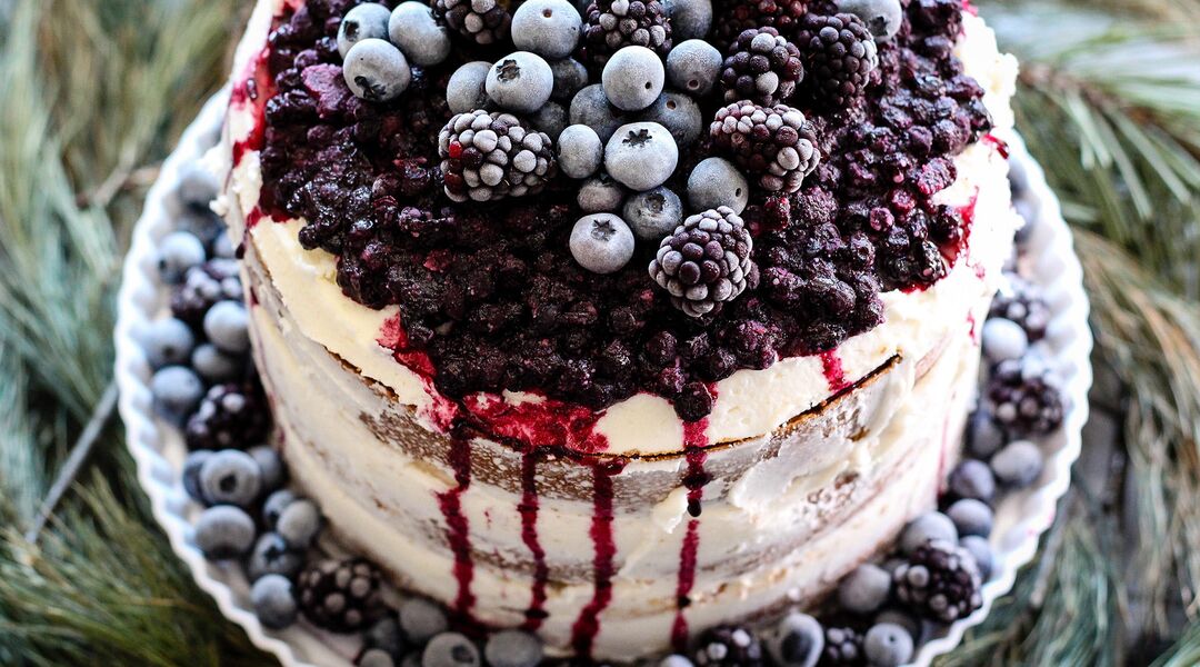 Baby shower dessert naked cake with berry compote