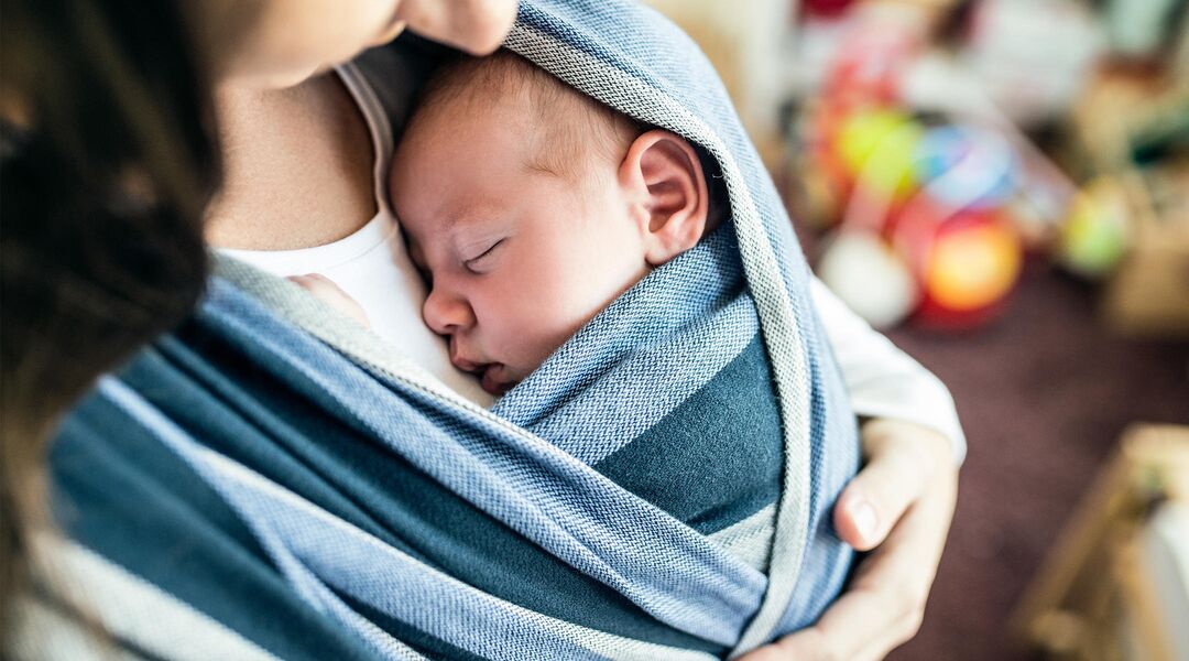 baby sleeping in wrap