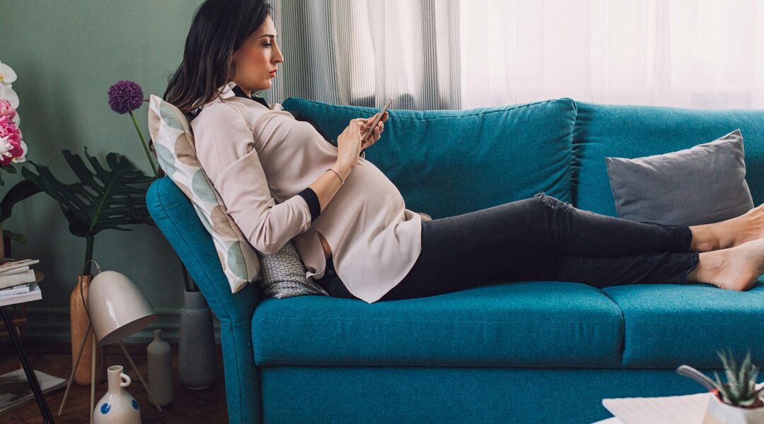 pregnant woman disappointed on couch 