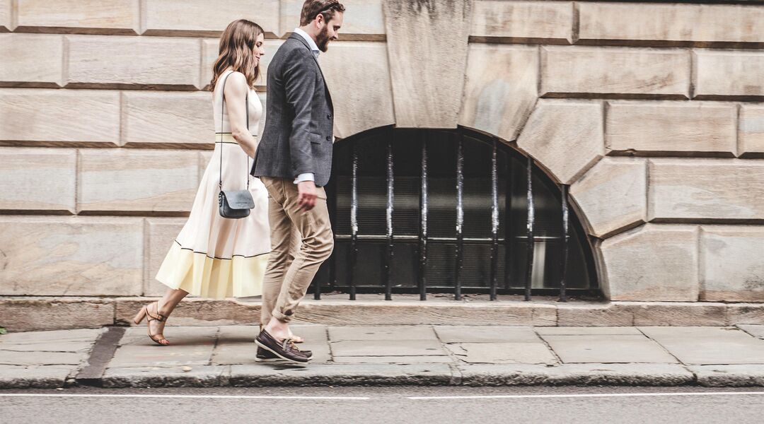 happy couple walking urban environment