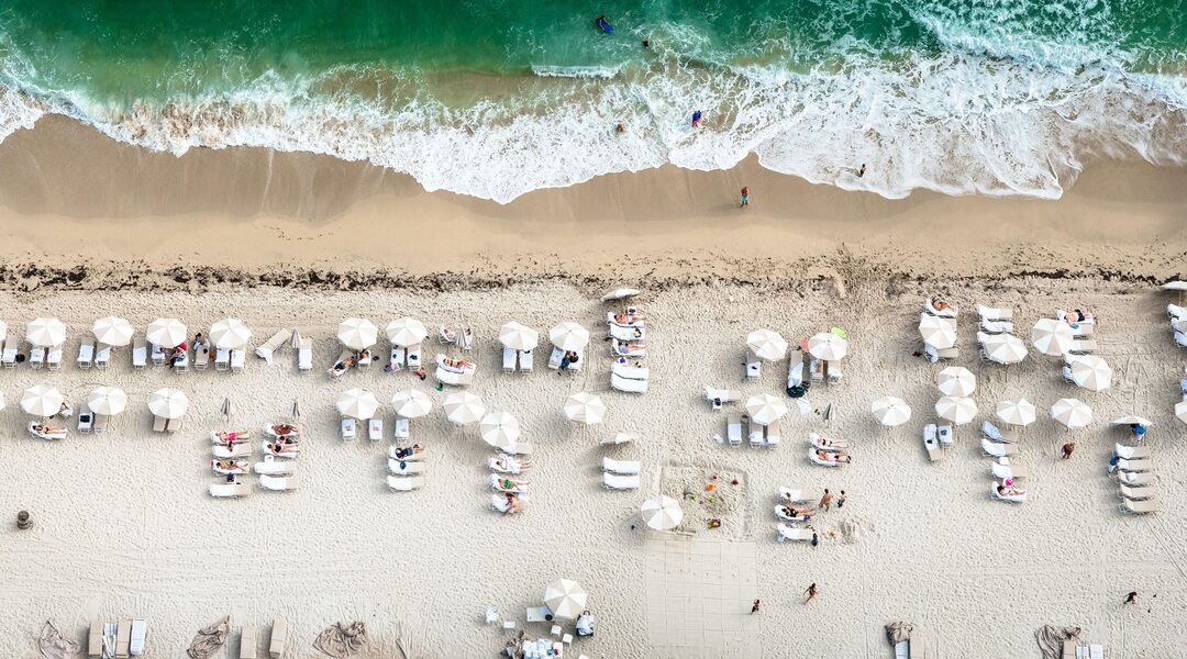beach scene people ocean umbrellas