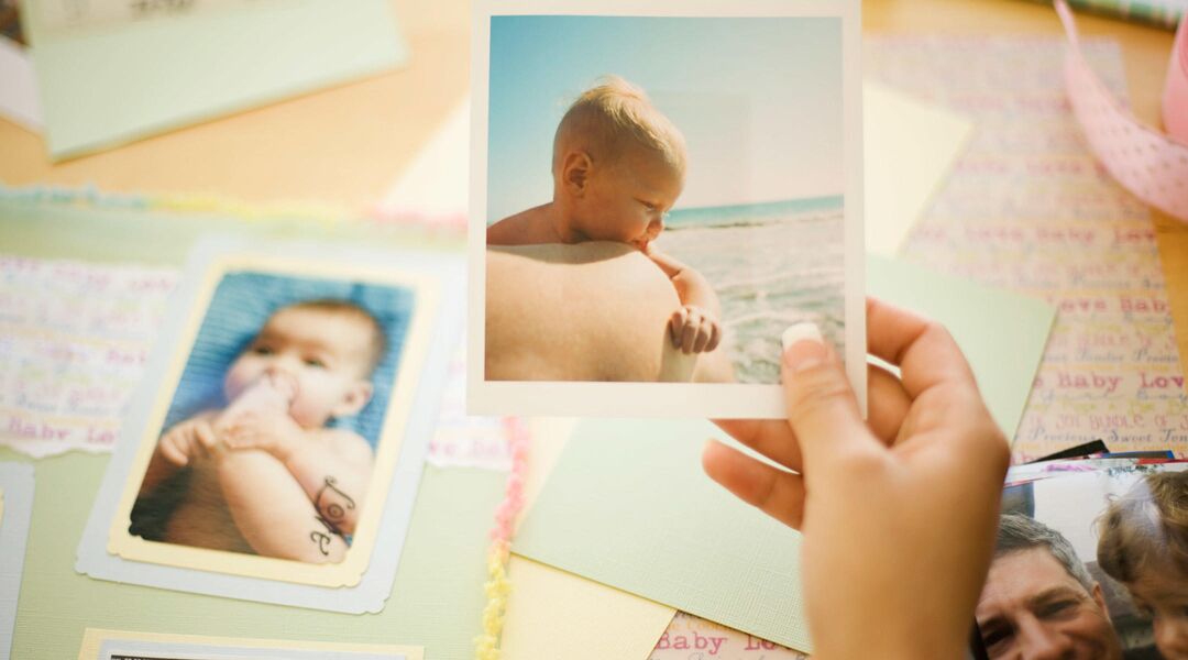 Mother looking at old photos of daughter