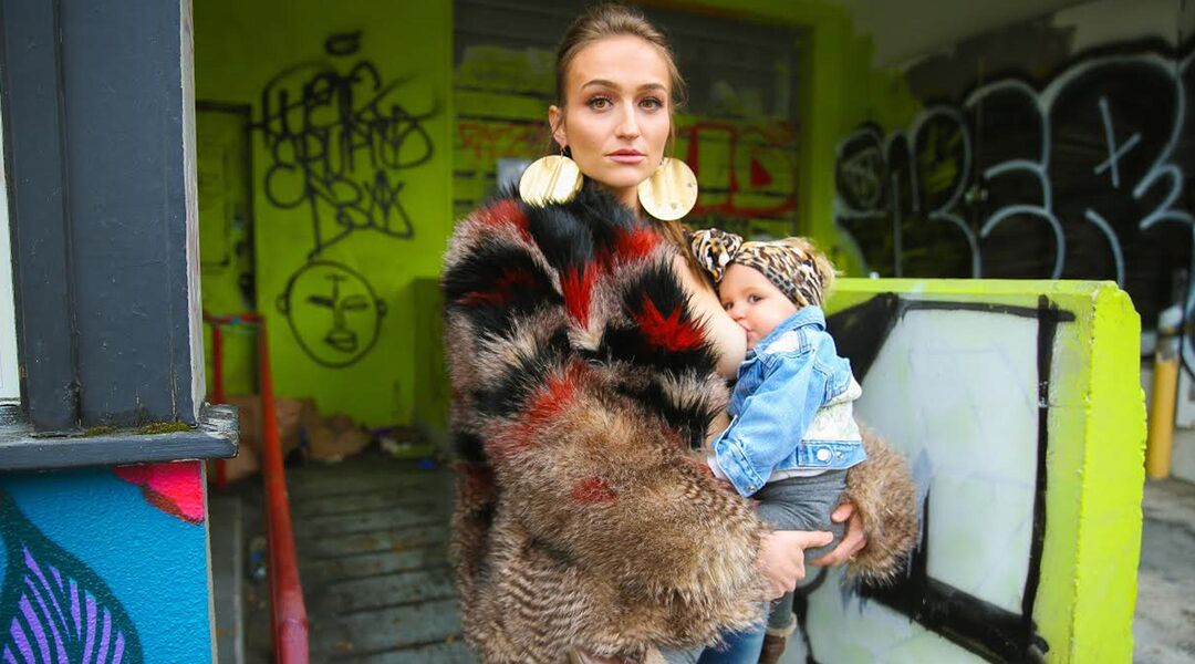 woman breastfeeding with graffiti background 