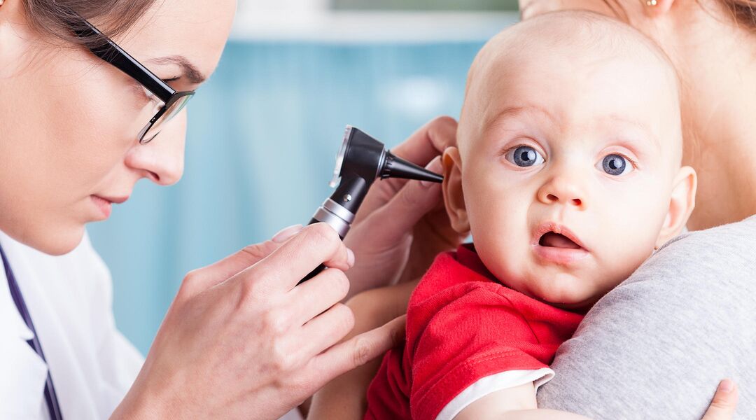Baby having his ear examined