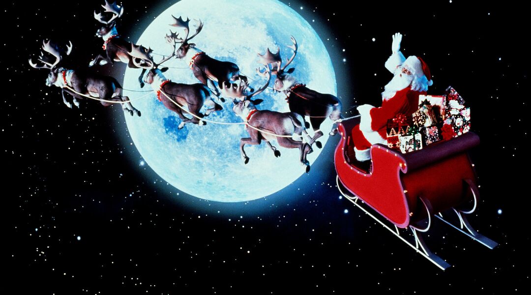 retro image of Santa Claus riding his sleigh past a full moon