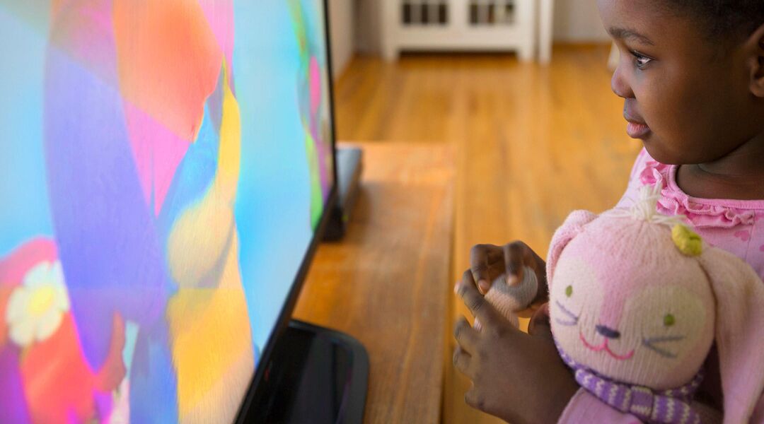 little girl watching tv close up in living room