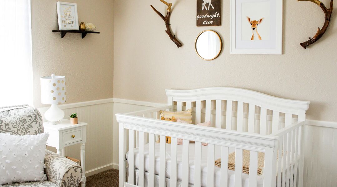 Interior of nursery with deer horns as wall decor and other deer artwork. 