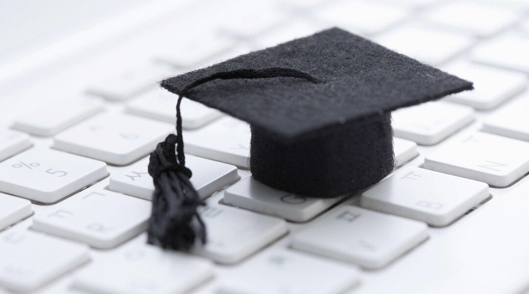 College graduation cap on laptop