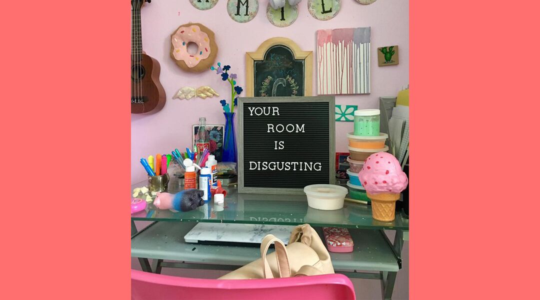 Letter board in teenage girl's room reading 'Your Room Is Disgusting'